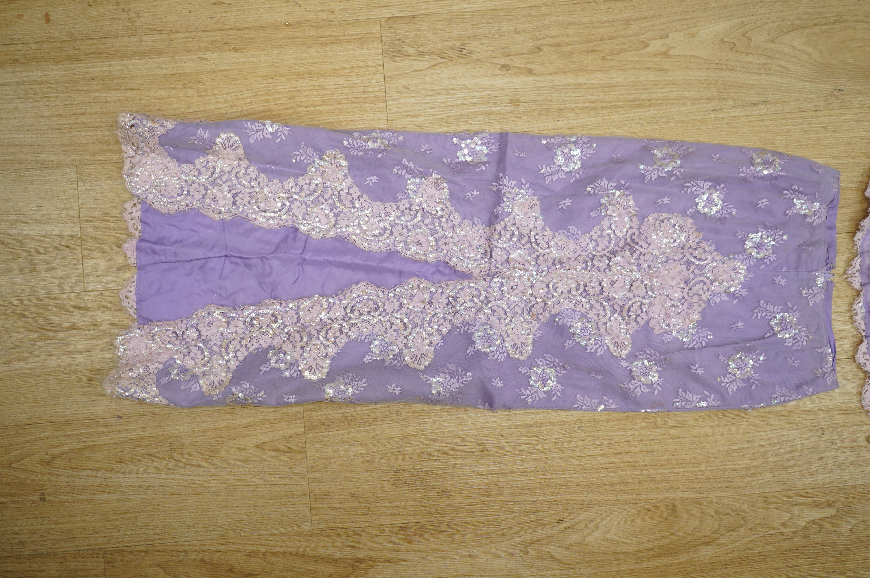 A late 20th century black sequinned, beaded and fringed evening dress, bust 36cm wide at front, together with a lilac chiffon, net, lace and sequin top and matching net evening skirt. Both outfits are a small size